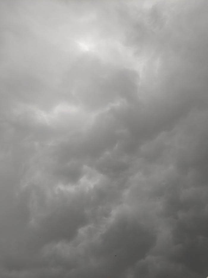 Monochrome shot of a moody sky filled with thick clouds, perfect for weather-themed projects.